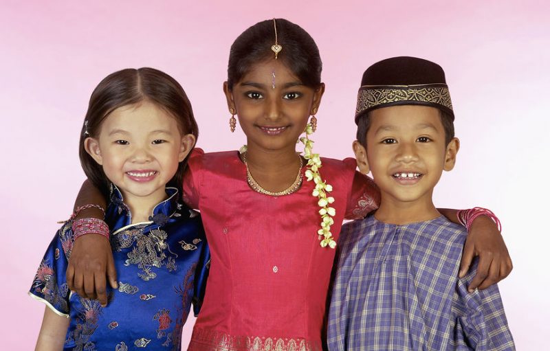 Young Malay Chinese And Indian Kids In Traditional Clothes Smiling And Hugging Each Other Kiasuparents